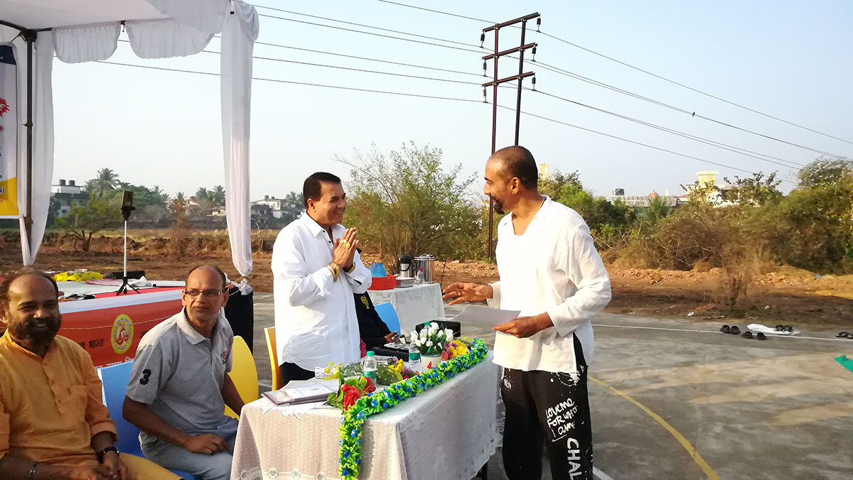 Certificate of participation being presented to Raj Bhandare by Sancoale Sarpanch and Chief Guest for the final day of Yoga Session, Shri Ramakant Borkar.